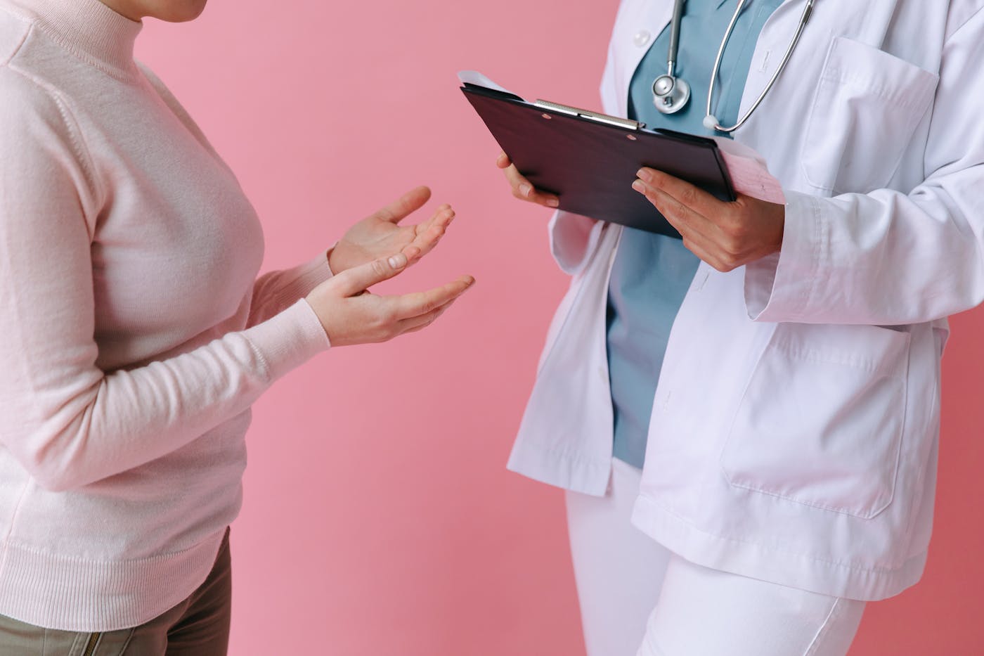Doctor consulting with a patient and clipboard