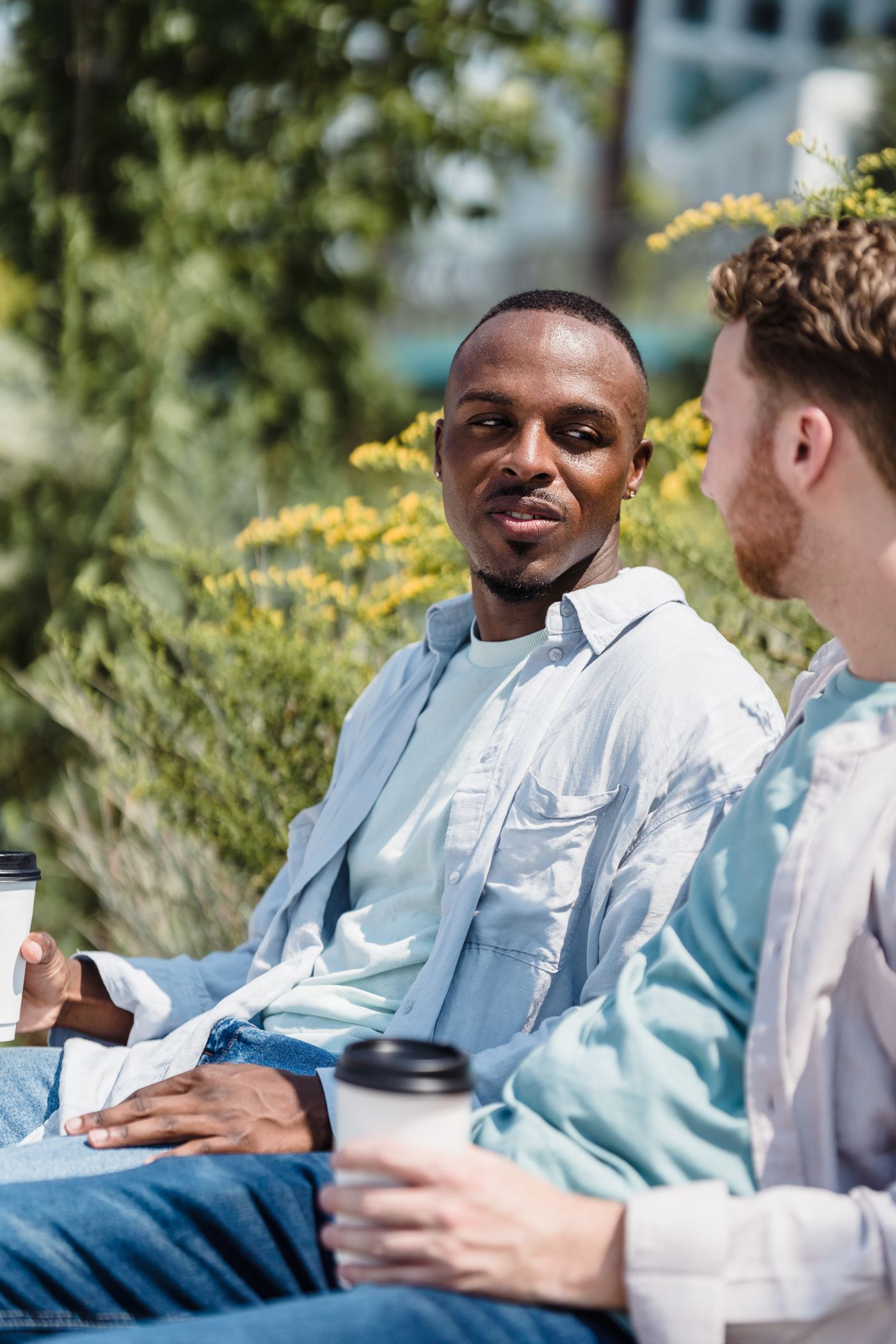 Two men sitting outdoors and talking together
